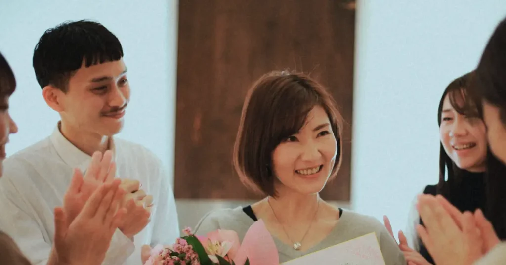 Employee smiling genuinely while receiving thoughtful budget recognition gift under twenty-five dollars creating authentic connection.