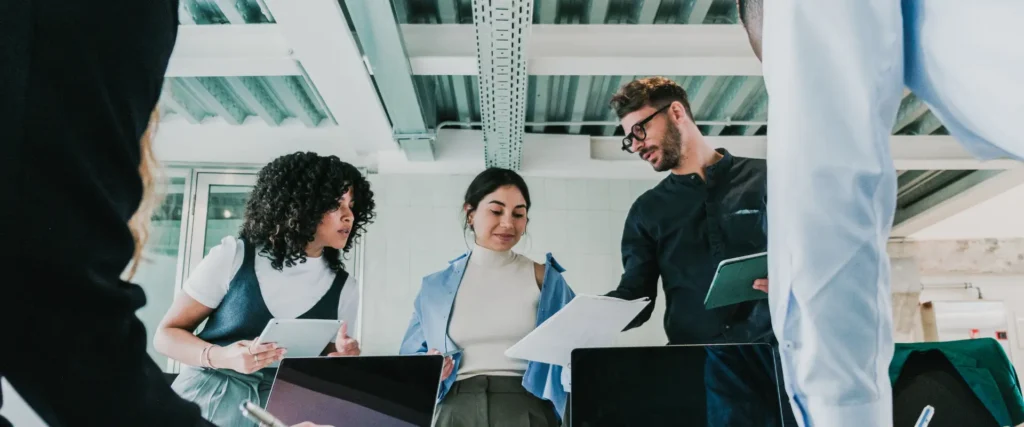 Team celebrating together in the office, symbolizing instant recognition and spot awards that boost employee morale.