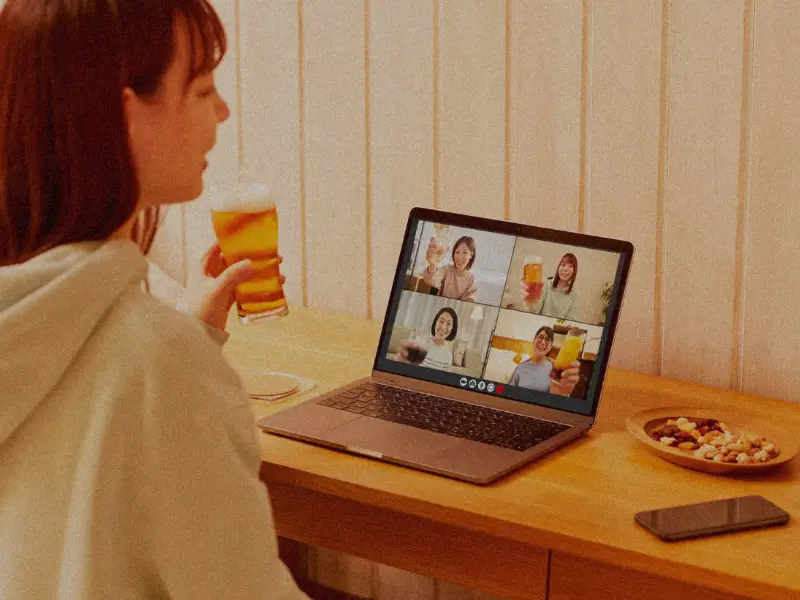 Diverse remote team members celebrating together virtually after receiving instant digital recognition gifts under twenty-five dollars.
