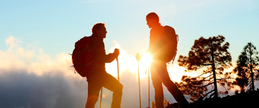 Two people hiking together, representing experience-based gifts that create lasting memories and deeper employee engagement.