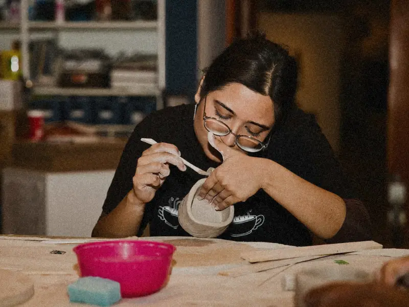 Diverse employees enjoying various experience gifts including cooking classes spa treatments concerts demonstrating personalized recognition impact. 